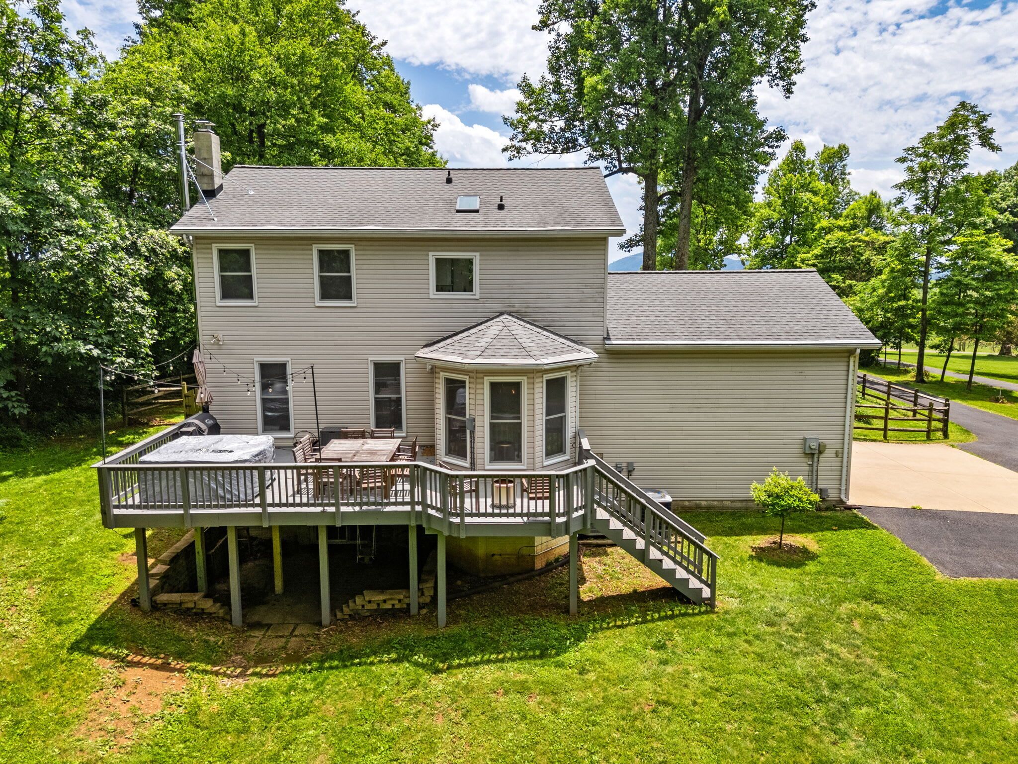 A two-story house with a covered patio and a separate garage.