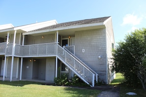 A multi-story building with a balcony and a staircase leading to the upper floor. - Thousand Islands Country Club (Wellesley Island)