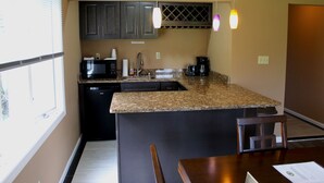 A compact kitchen with a microwave, coffee maker, and sink. - Thousand Islands Country Club (Wellesley Island)