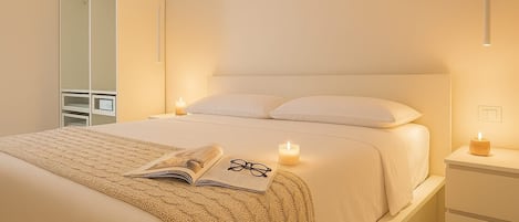 A bedroom with a bed, bedside table, and a wardrobe.