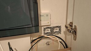 An open electrical panel with visible wiring and a door handle. - "Les Pistes" Chalet (Ax-les-Thermes)