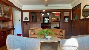 A living room with a sofa, two armchairs, a coffee table, and a potted plant. - Hollywood Hills Home with Casita: Perfect Multi-Generational Family Compound (Los Angeles)