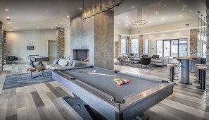 A spacious indoor area with a pool table, seating, a fireplace, and large windows. - Safari Luxury Tent - Couples Getaway,30 Min. to Sedona (Camp Verde)