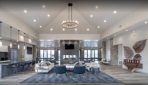 A spacious living area with a fireplace, modern furniture, and a large chandelier. - Safari Luxury Tent - Couples Getaway,30 Min. to Sedona (Camp Verde)