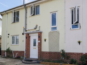A two-story residential building with a white door, multiple windows, and a brick base. - 167 Leybourne Avenue (Bournemouth)