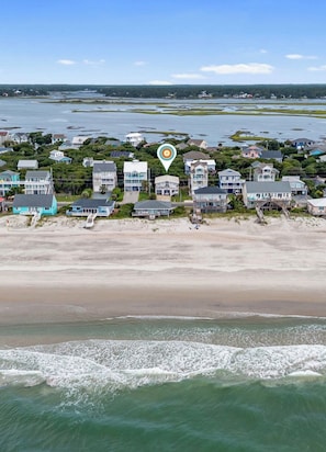 A coastal residential area with houses along the beachfront, a clear sky, and calm sea. - Casa Palmera Surf City - 4BR/3BTH - Ocean Views - Game/Rec Room - Sleeps 10 (Surf City)