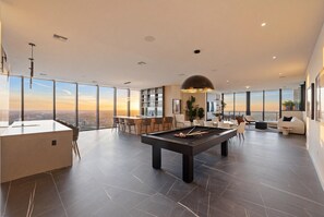 A modern living room with a pool table, bar area, and seating. - E11EVEN Presidential Penthouses (Miami)