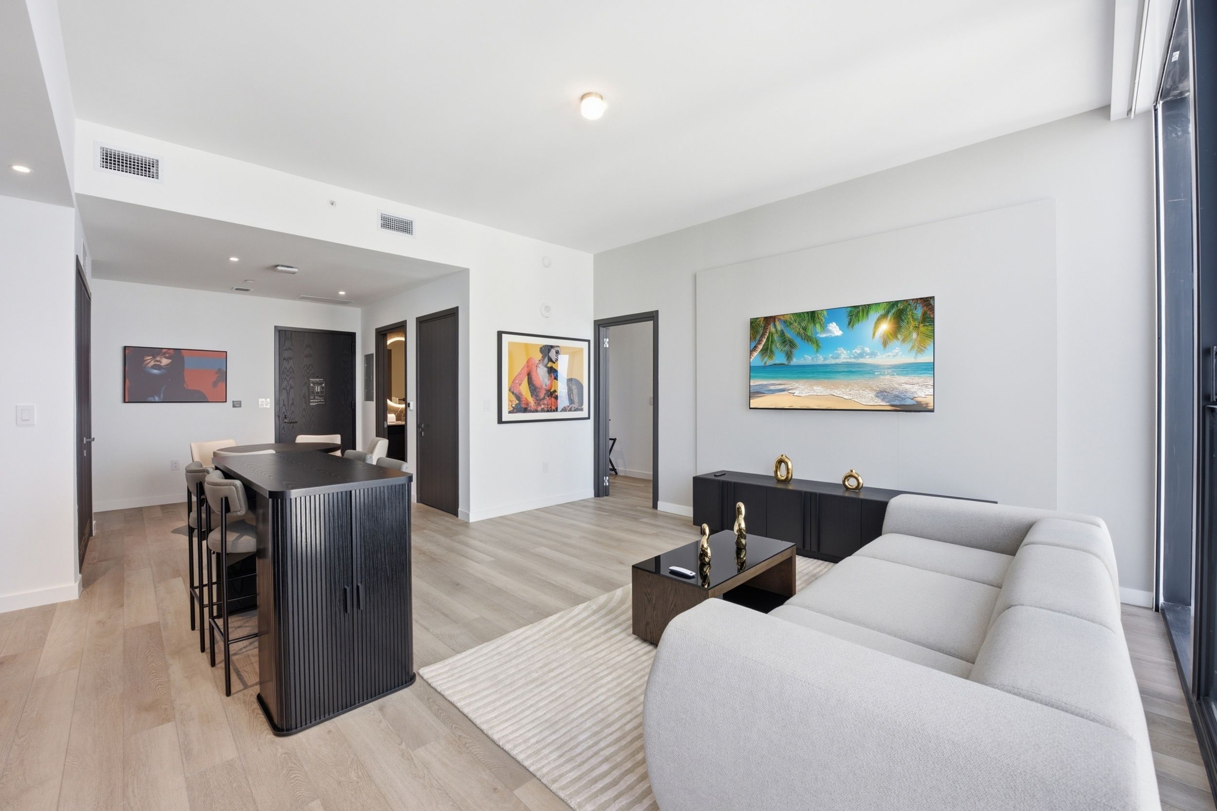 A modern living room with a sofa, a coffee table, and artwork on the wall.