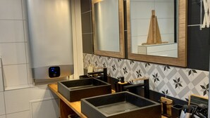 A modern bathroom with a wooden vanity, three sinks, a large mirror, and a wall-mounted heater. - Provençal cottage (Roquebrune-sur-Argens)