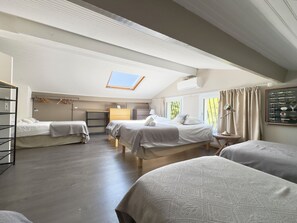 A room with two beds, a desk, a chair, a wardrobe, and a skylight. - VillaSerenita Heated Pool, Jacuzzi, Ping Pong (ALATA)