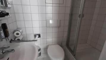 A bathroom with a sink, toilet, and shower.