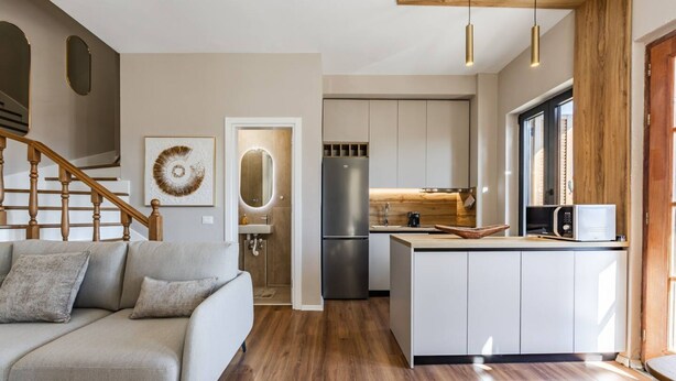 A modern kitchen with a wooden island, stainless steel appliances, and a built-in microwave. - Villa Bora No 7 Belvedere Kor a (Qendër Bulgarec)