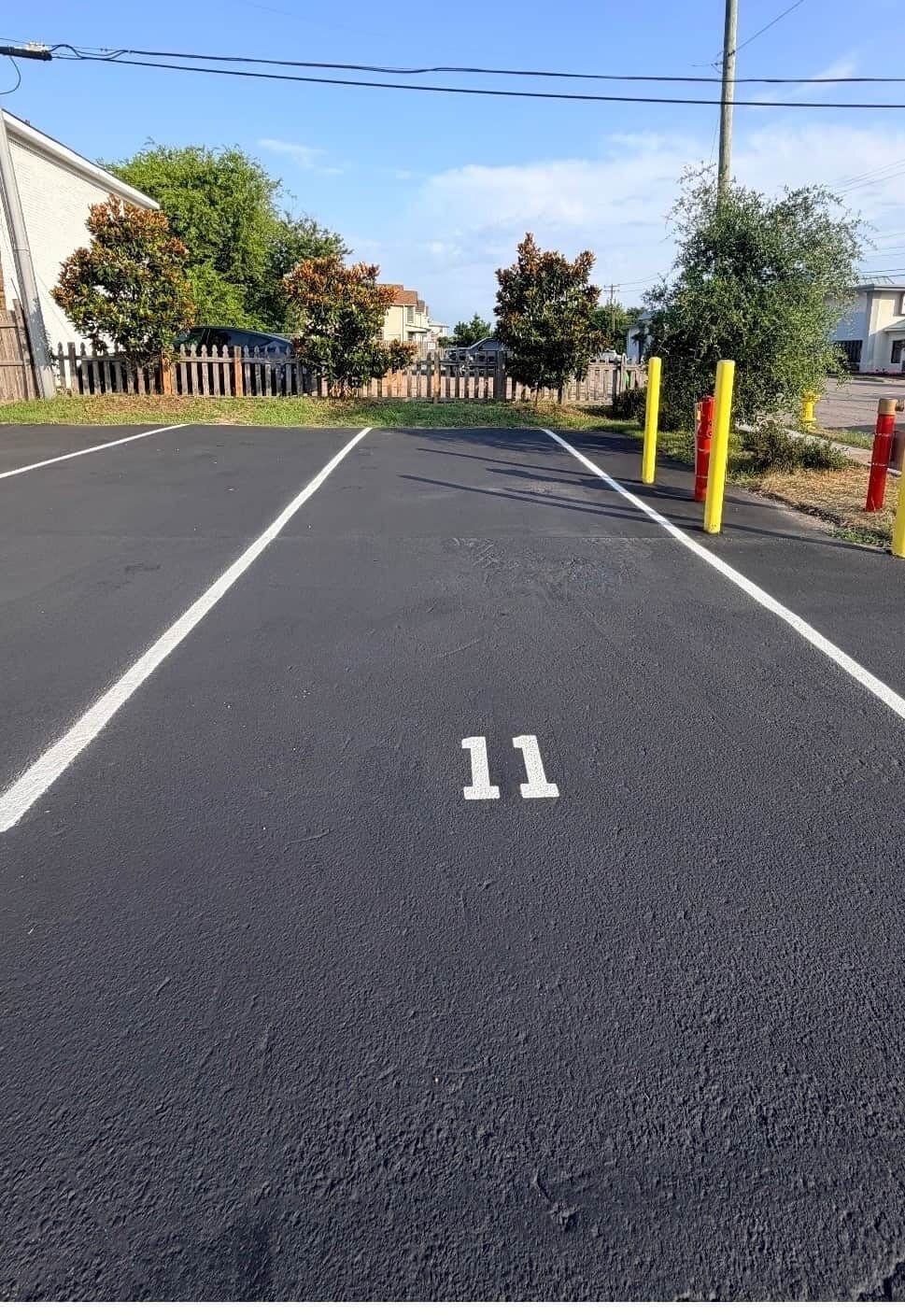 A parking lot with white lines and the number 11 painted on the ground.