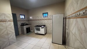 A compact kitchen with a gas stove, a refrigerator, and a sink.