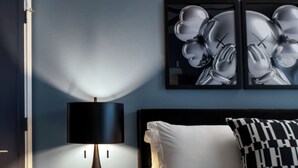 A bedroom with a bed, a bedside lamp, a wall-mounted picture, and a nightstand. - Luxe Modern Artsy TH in Tampa Heights/Next to Downtown/Everything You Need (Tampa)