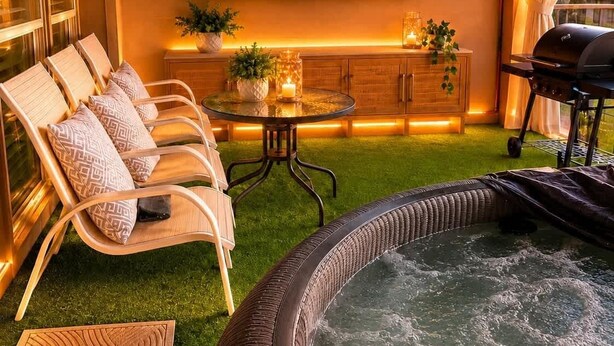 A room with a Netflix sign, a hot tub, lounge chairs, and a grill. - Regent Villa | Theatre | Hot Tub | Game Room | BBQ (Plano)
