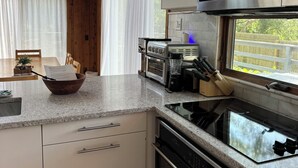 A modern kitchen with a built-in microwave, stove, and dishwasher.