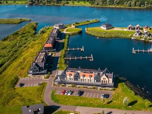 An aerial view of a lakeside property with a central building, connected docks, and a parking area. - Holiday Home in Kampen With Terrace (Kampen)