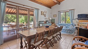 A dining area with a wooden table and chairs, a sofa, and a fan. - Mas Goya, a peaceful villa on the gentle slopes below the pretty hill-top village of Tourtour. (Tourtour)