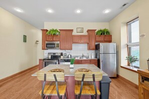A modern kitchen with wooden cabinets, stainless steel appliances, and a granite countertop. - The Urban Botanist-Botanical Garden/ZOO/The Grove/Tower Grove Park (St. Louis)