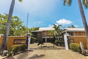 A gated entrance with a sign reading 'BOUGAINVILLE NO.125.' - Tropical beachfront getaway with private pool, ocean views & enclosed yard (Placencia)