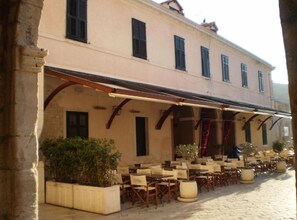 A building with outdoor seating, a covered patio, and a sign that reads 'Ristorante.' - Old Port Stay (Dubrovnik)