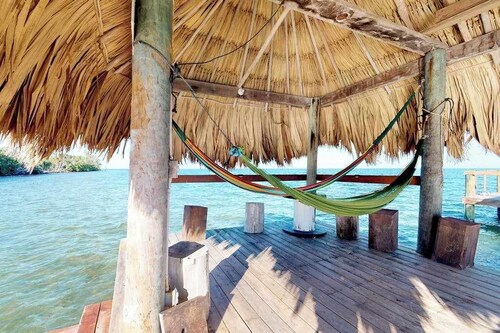 Beachfront home with dock, deck, hammocks, strong WiFi, AC & sea view