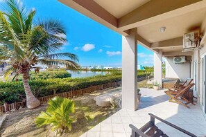 Terrace/patio - Vibrant, colorful lagoon-front suite with pool access, scenic patio, & WD (San Pedro)
