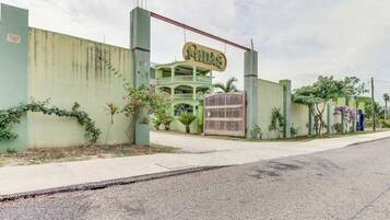 A building with a sign that reads 'MHDAS' and a gated entrance.