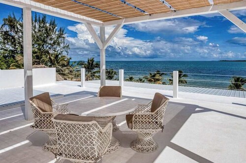 Luxurious beachfront home with private pool, rooftop grill, and sea views