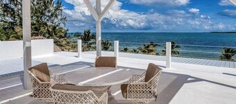 Luxurious beachfront home with private pool, rooftop grill, and sea views