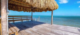 Dazzling beach stay with a balcony - pool, bikes, canoes, grill, & dock access