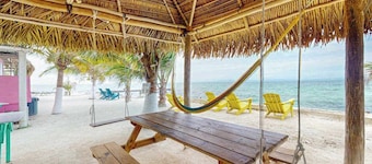 Overwater cabin with oceanfront deck, island kitchen & sea breeze views