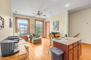 A spacious kitchen with a dining area, wooden flooring, and large windows. - The Shaw Collective-Botanical Garden/ZOO/The GROVE/Tower Grove Park (St. Louis)