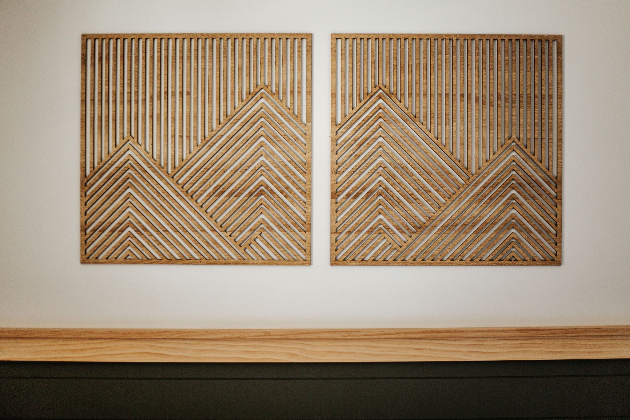 Two wooden wall panels with geometric patterns.