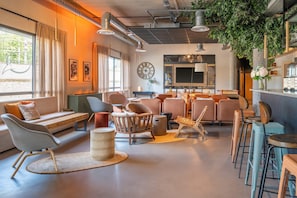 A modern living room with a sofa, chairs, a coffee table, and a fireplace. - Best Western Plus Hotel De Robien (Saint-Brieuc)