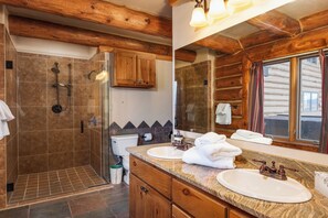 A bathroom with two sinks, a shower, and wooden beams on the ceiling. - Mountain Wedding & Retreat Destination with Private Lodge, 55 acres, Sleep 37 (Granby)