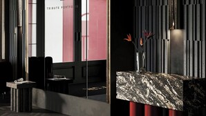 A reception area with a marble counter, a glass door with a logo, and a modern interior design. - The Brick, a Tribute Portfolio Hotel - Adults Only (Gdansk)