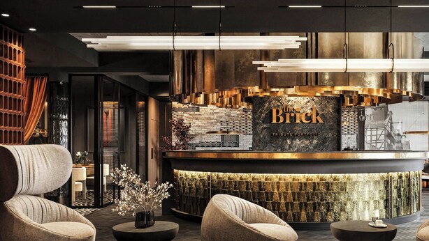 A modern lobby with a reception desk, seating area, and decorative wall panels. - The Brick, a Tribute Portfolio Hotel - Adults Only (Gdansk)