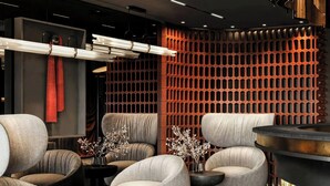 A modern lobby with seating, a reception desk, and a patterned floor. - The Brick, a Tribute Portfolio Hotel - Adults Only (Gdansk)