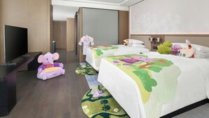 A hotel room with a large flat-screen TV, two beds with colorful bedding, plush toys, and a modern design. - Marriott Shanghai Hotel Songjiang (Shanghai)