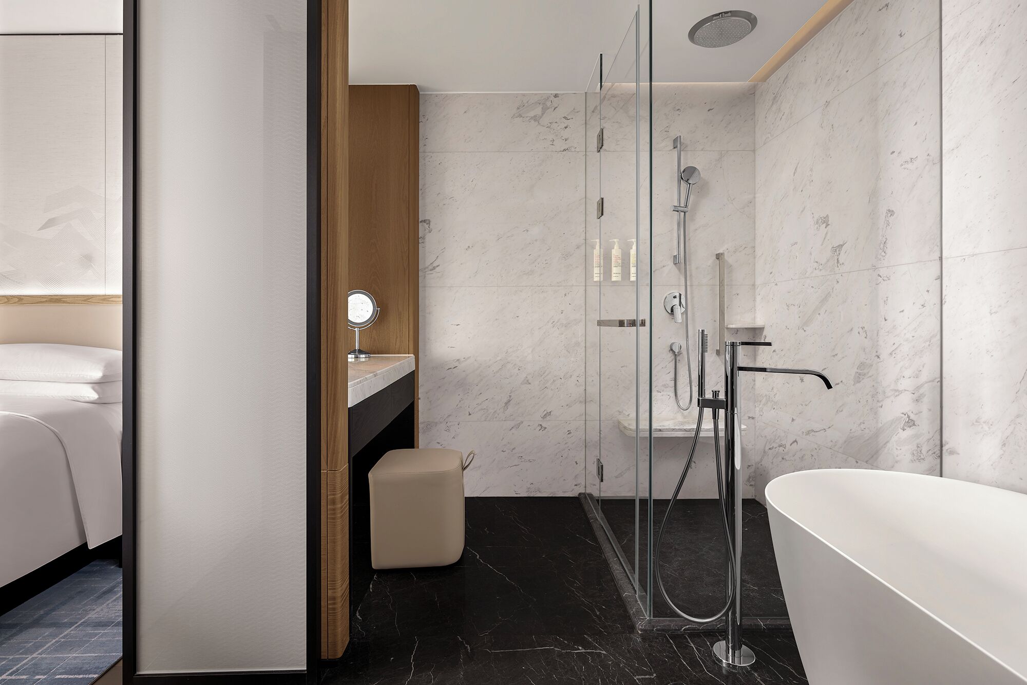 A modern bathroom with a glass-enclosed shower, a freestanding bathtub, and a vanity with a mirror.