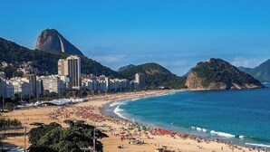 A coastal cityscape with a prominent mountain, beach, and urban buildings. - Apartment With sea View in RJ Brt1001 (Rio de Janeiro)