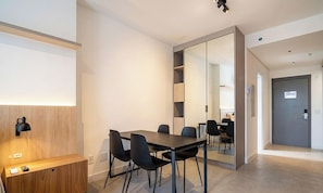 A modern conference room with a long table, black chairs, and a large mirror. - Studio in Condo w/ Gym in Trindade Vtd0610 (Florianópolis)