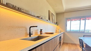 Eine moderne Küche mit Holzarbeitsplatte, Spüle und einem Fenster mit Blick.