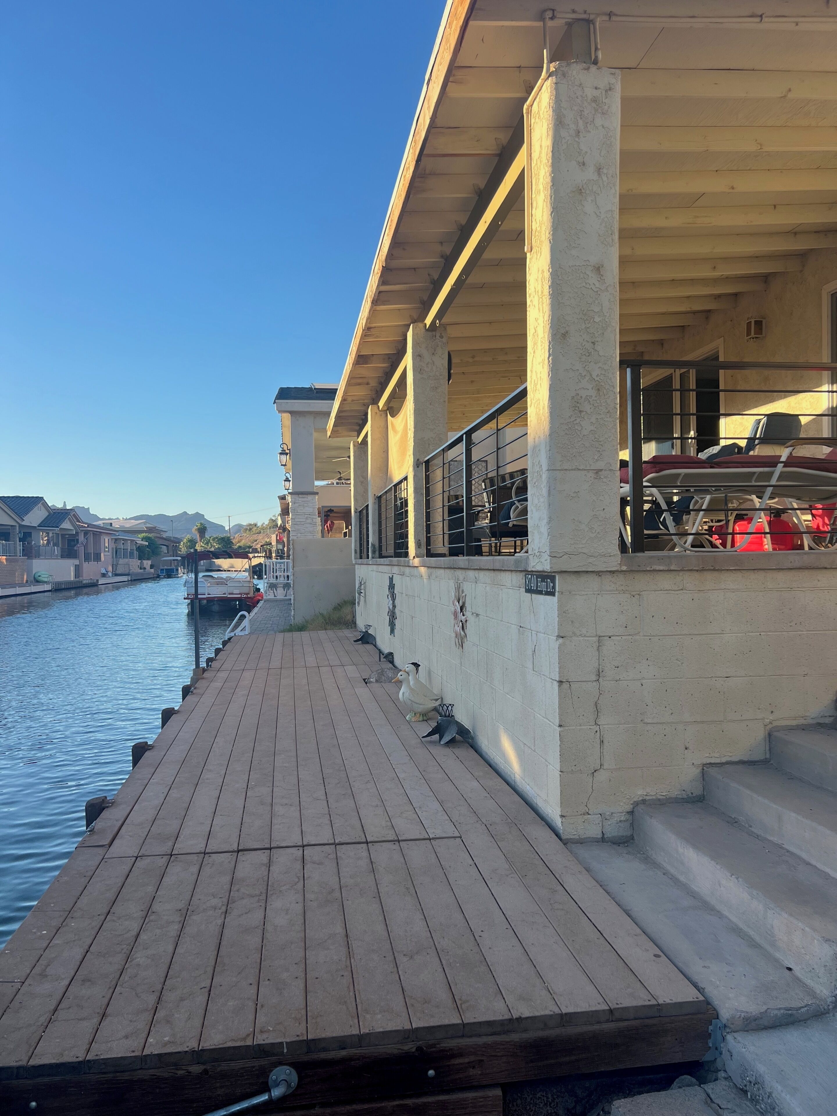 Waterfront dock and enclosed porch with grill and fire pit. 