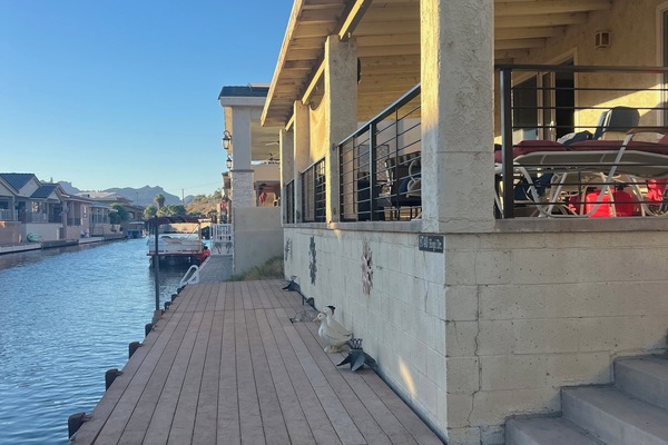 Waterfront dock and enclosed porch with grill and fire pit.