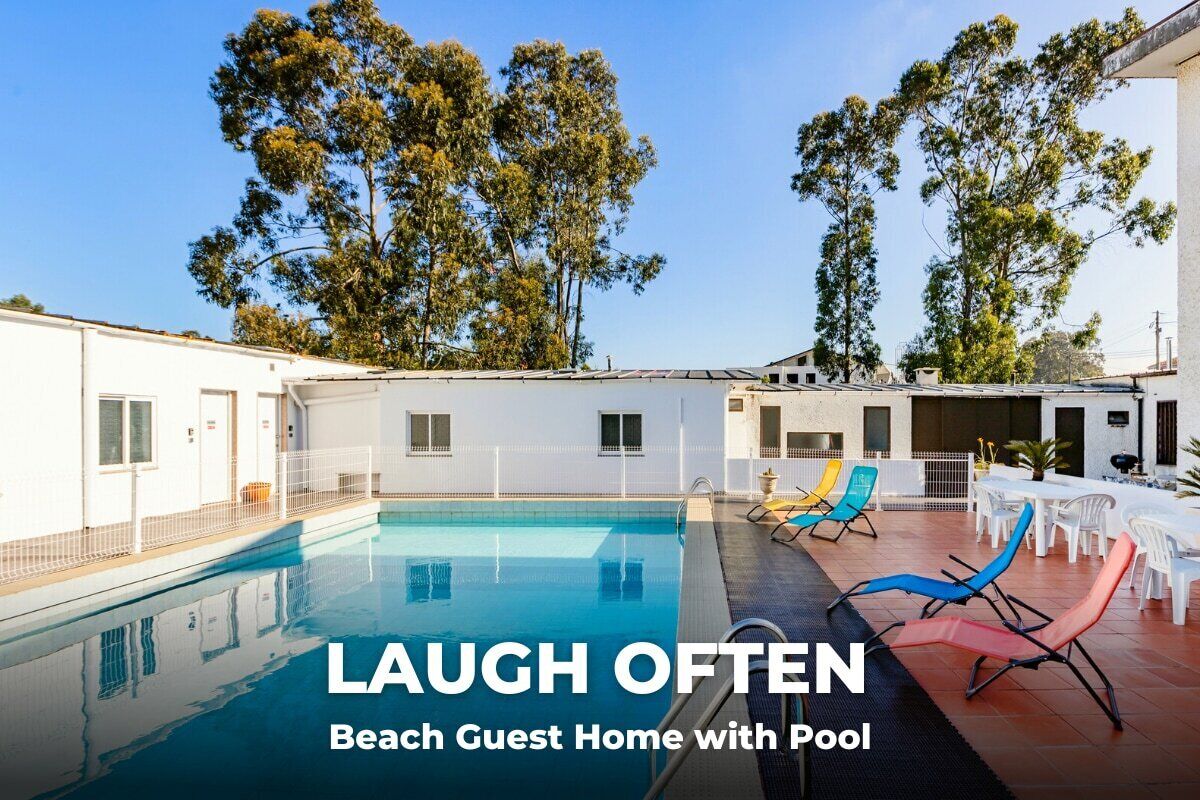 A beach guest home with a pool, including a patio area with lounge chairs and a dining table.