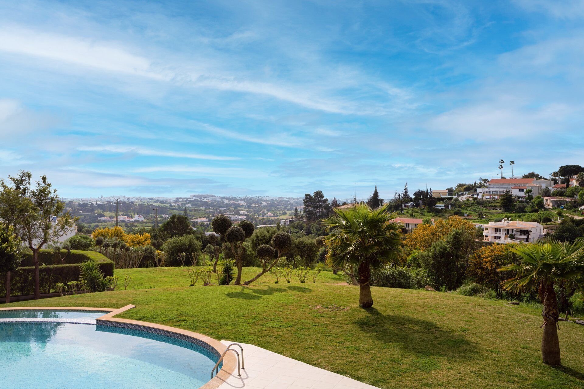 A swimming pool with a view of a cityscape in the background.