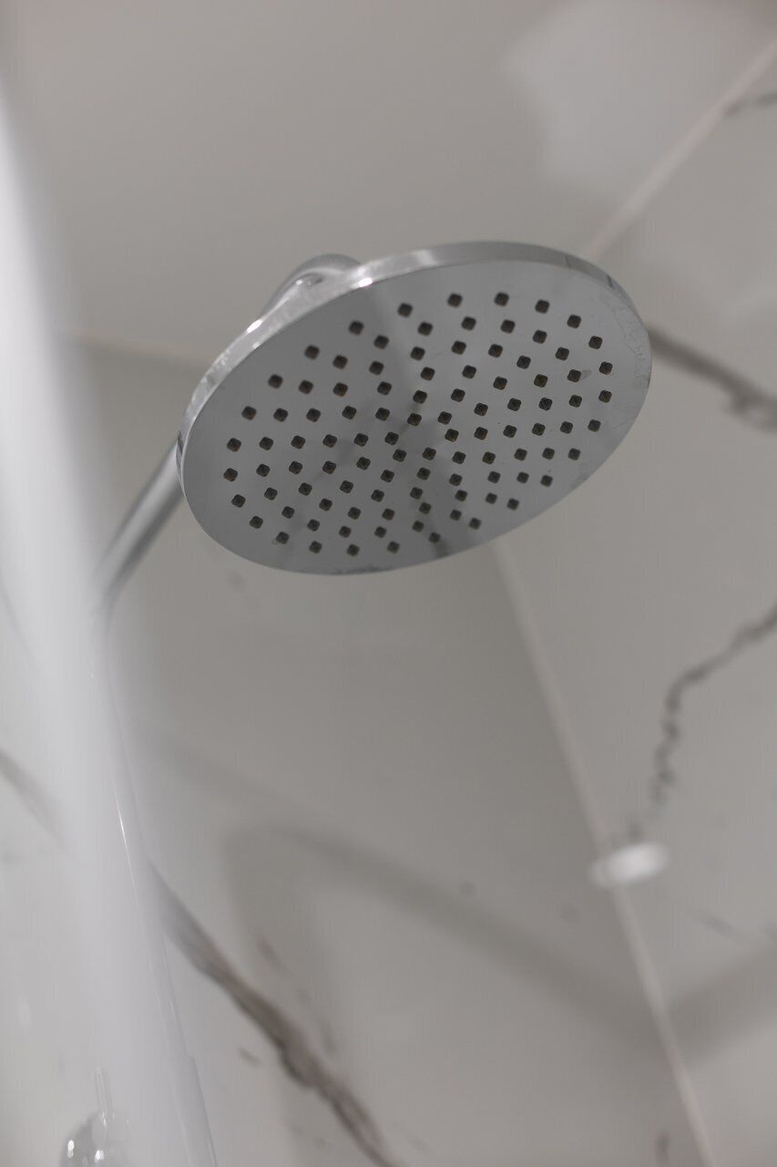 A showerhead with a perforated design.